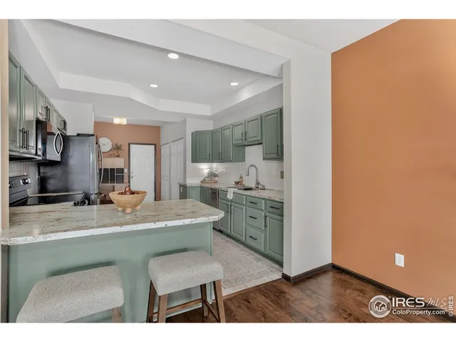 a view of kitchen with kitchen island a sink stainless steel appliances and cabinets