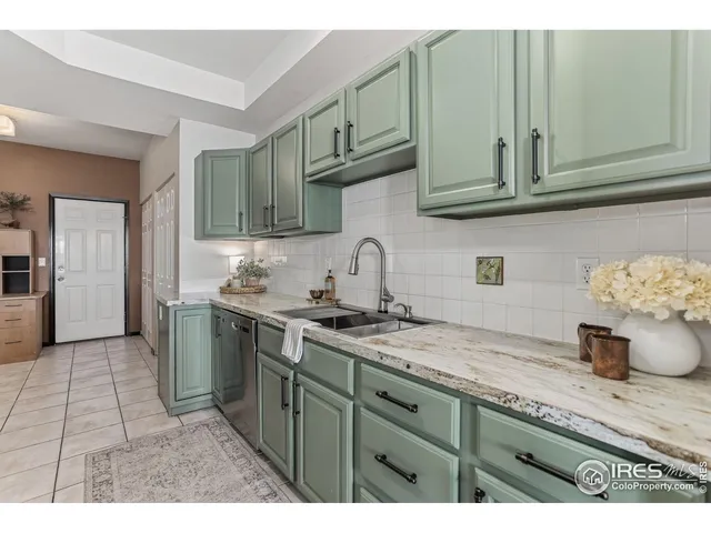 a kitchen with stainless steel appliances granite countertop a sink a stove and cabinets