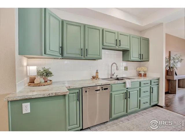 a kitchen with cabinets a sink and appliances