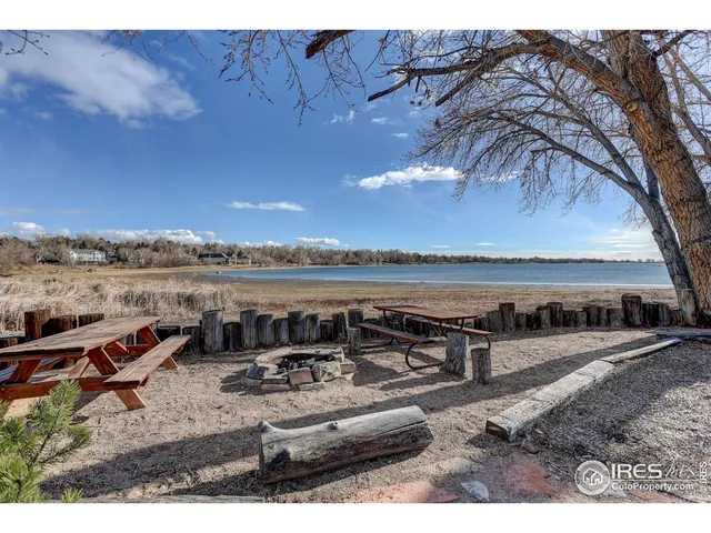 a view of a lake with a table and chairs