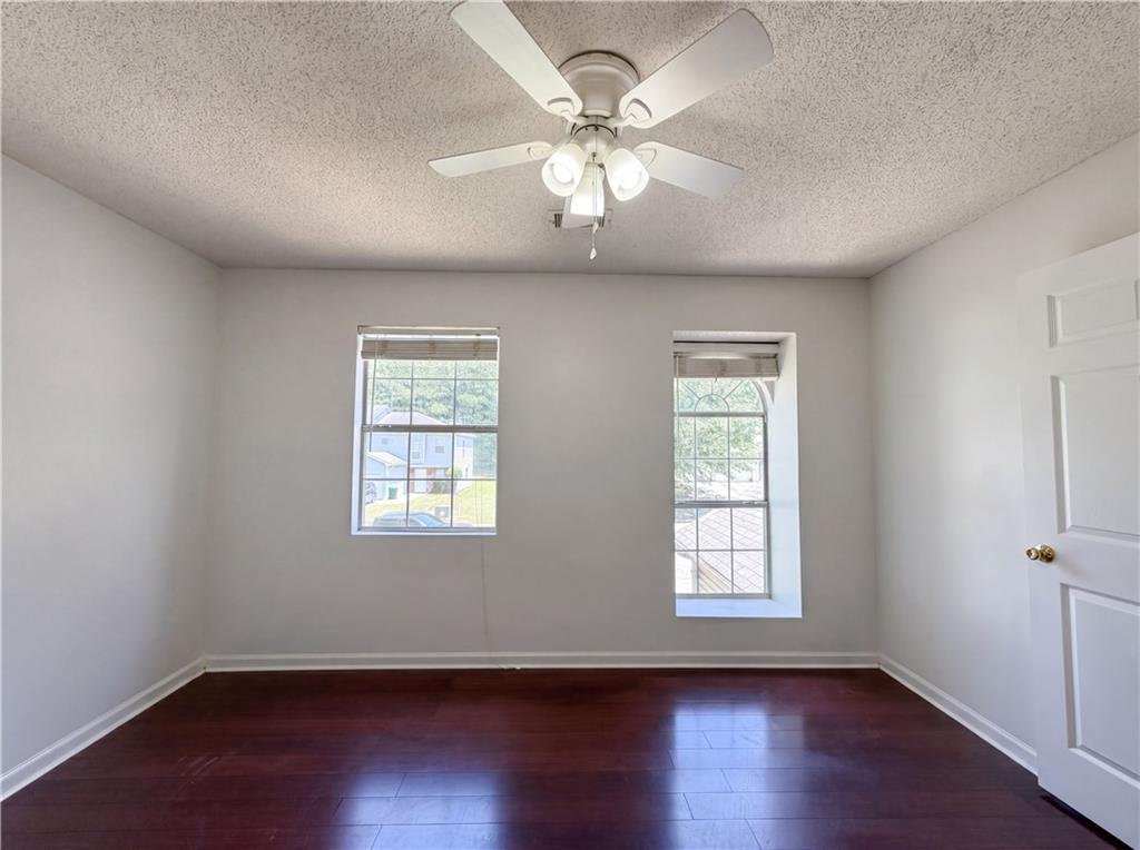 3753 Soapstone Road Decatur, GA 30034 - Photo 4 of 26 a view of an empty room with wooden floor and a window