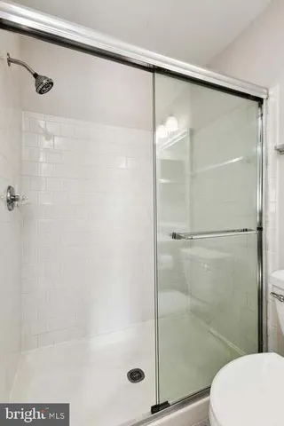 a bathroom with a glass shower door