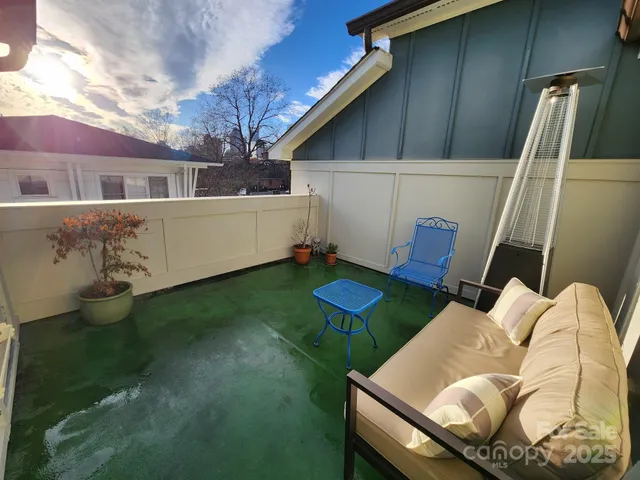 a view of backyard of house with seating space