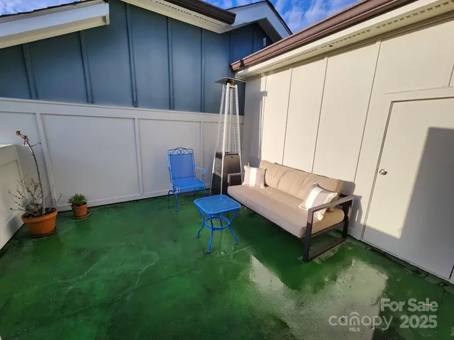 a view of a backyard with sitting area