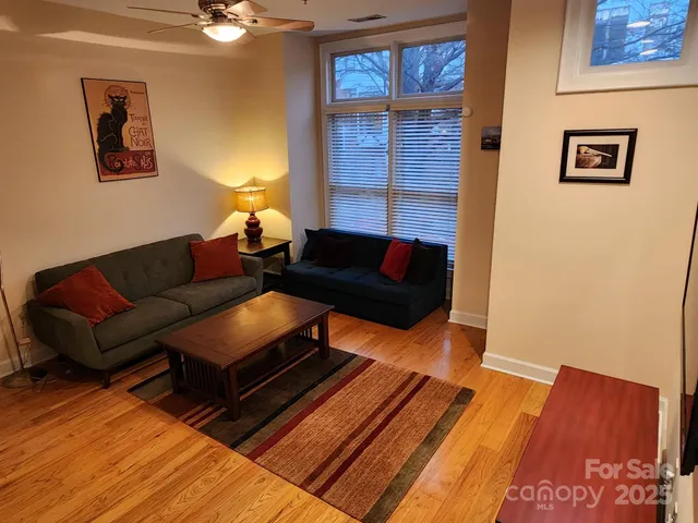a living room with furniture and a wooden floor