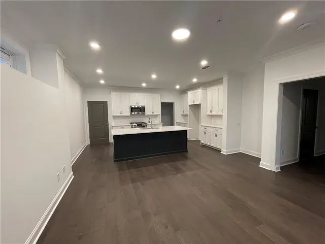 a view of kitchen with refrigerator and window