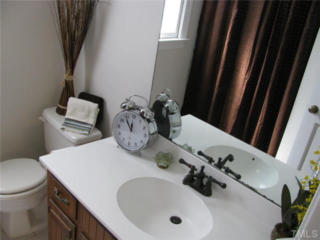 1124 Old English Court Raleigh, NC 27615 - Photo 8 of 12 a bathroom with a sink and a toilet
