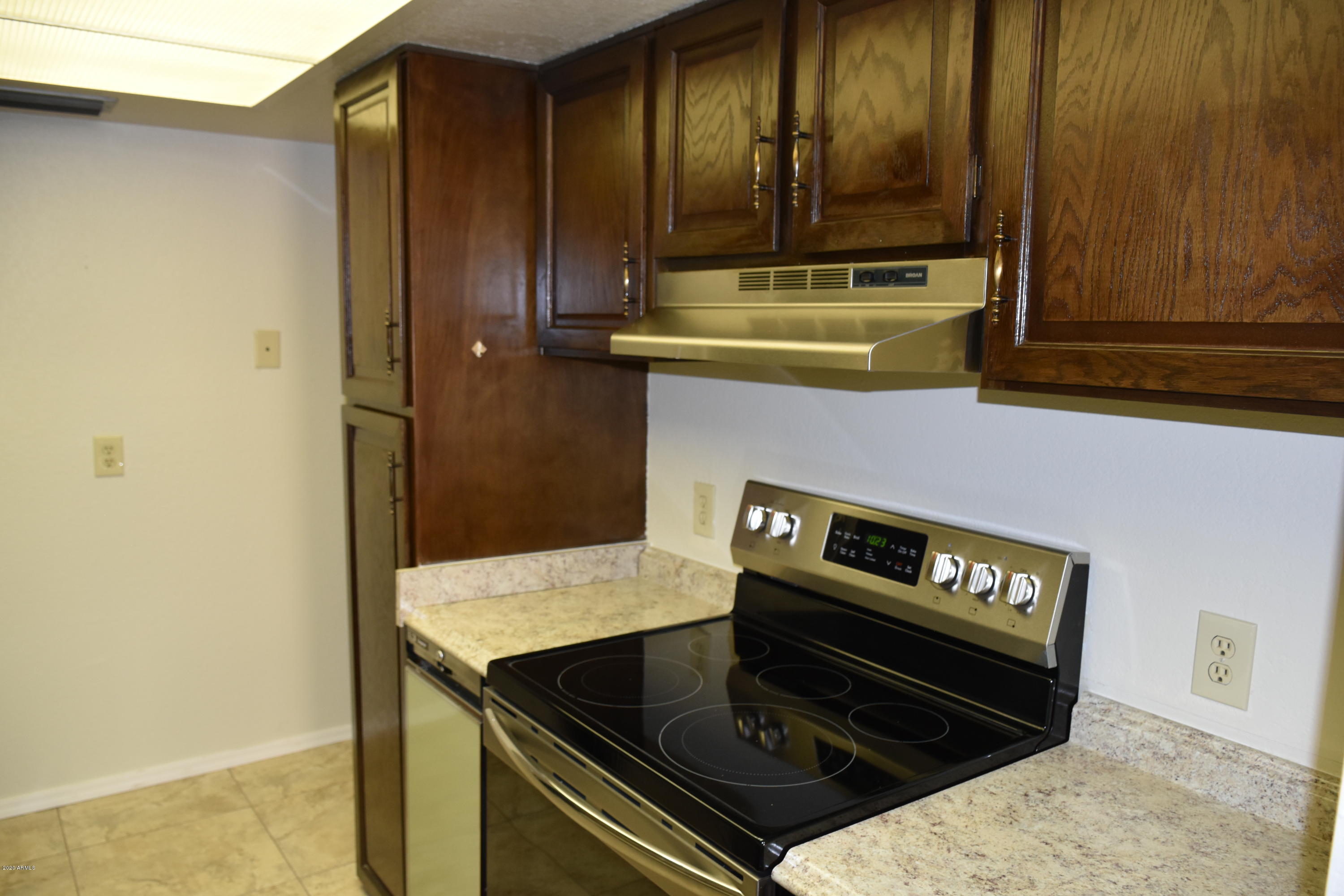2060 South Rural Road, Unit C Tempe, AZ 85282 - Photo 3 of 8 a kitchen with a stove and a refrigerator