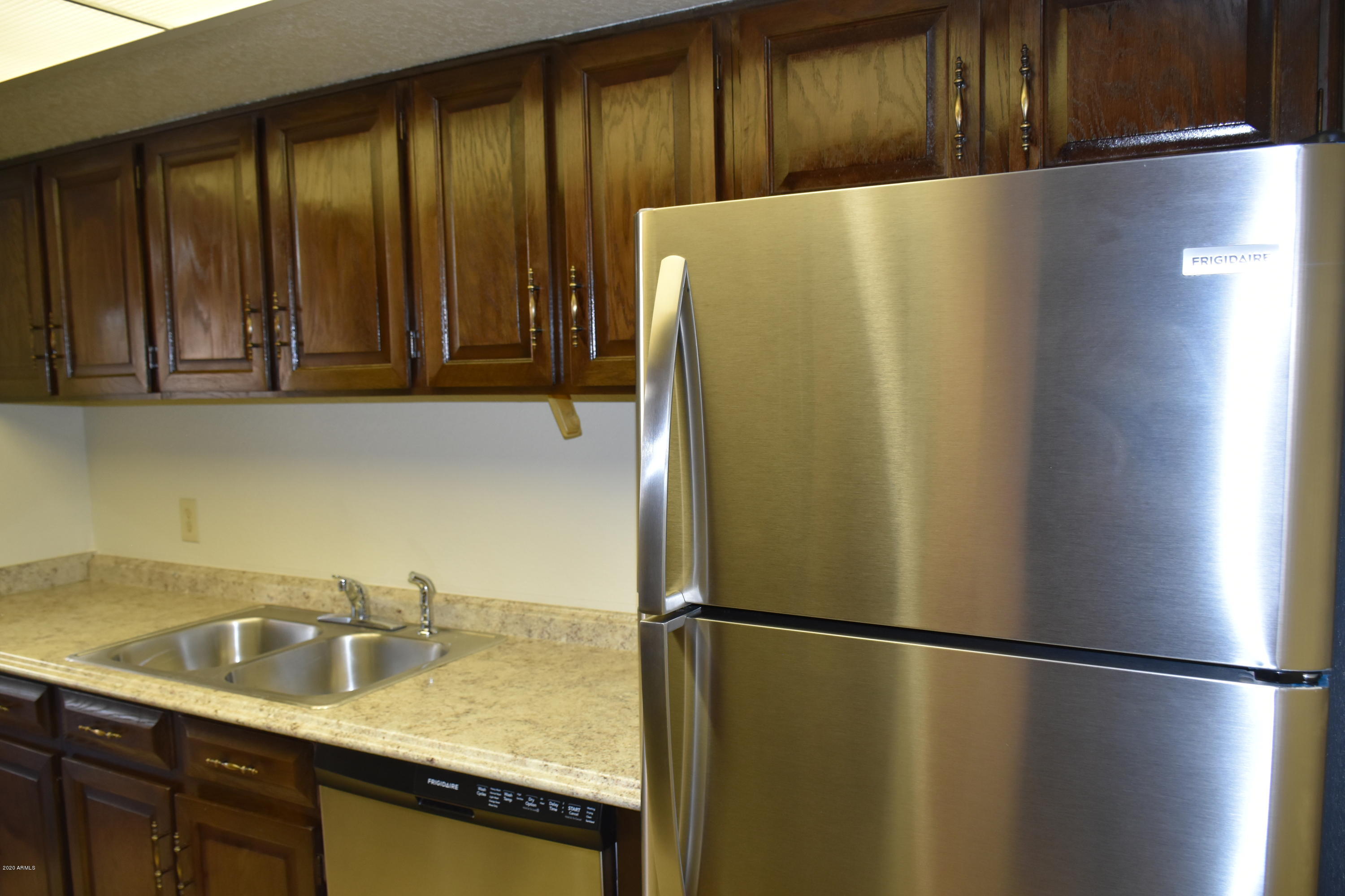 2060 South Rural Road, Unit C Tempe, AZ 85282 - Photo 4 of 8 a white refrigerator freezer sitting in a kitchen