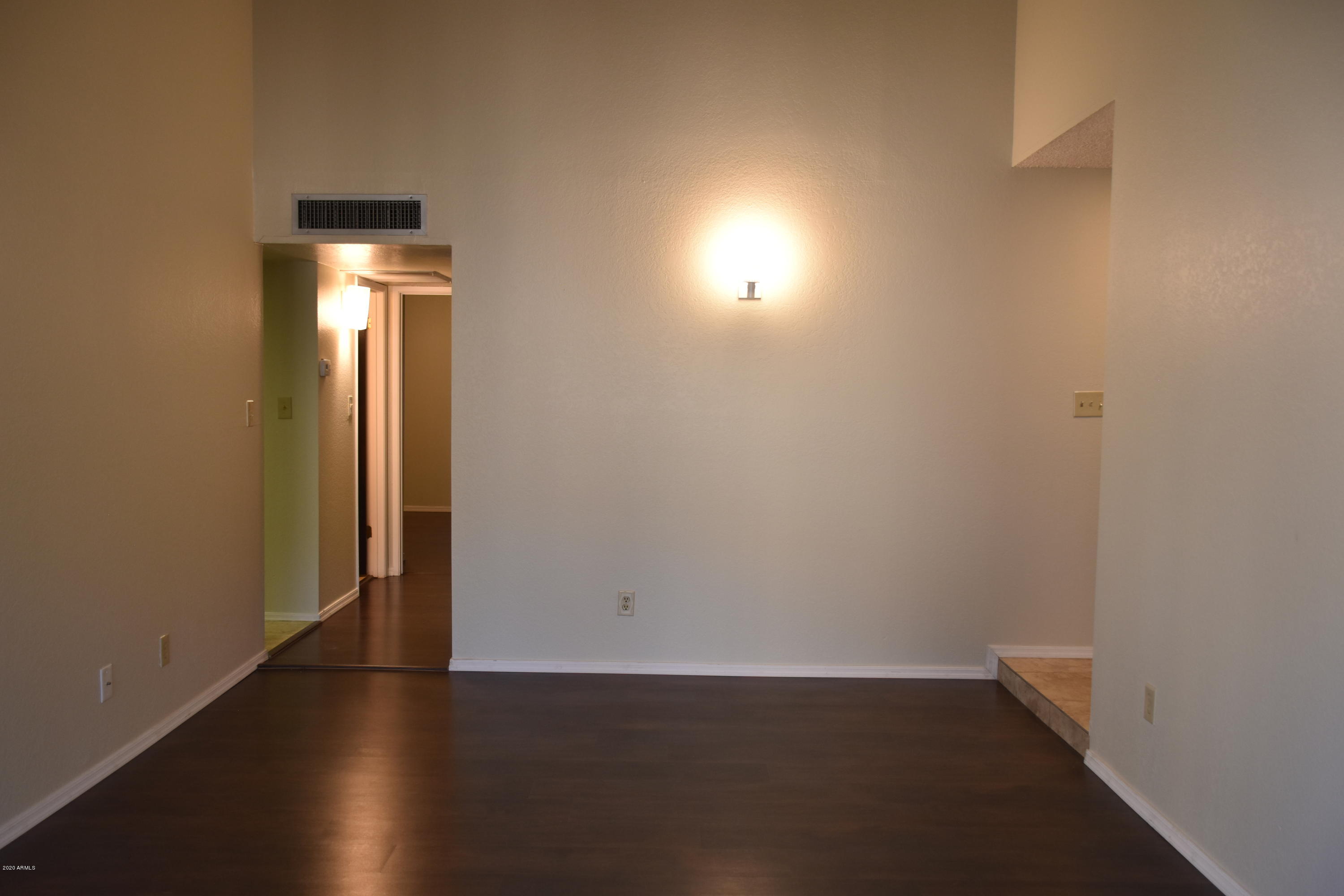 2060 South Rural Road, Unit C Tempe, AZ 85282 - Photo 5 of 8 an empty room with wooden floor and windows