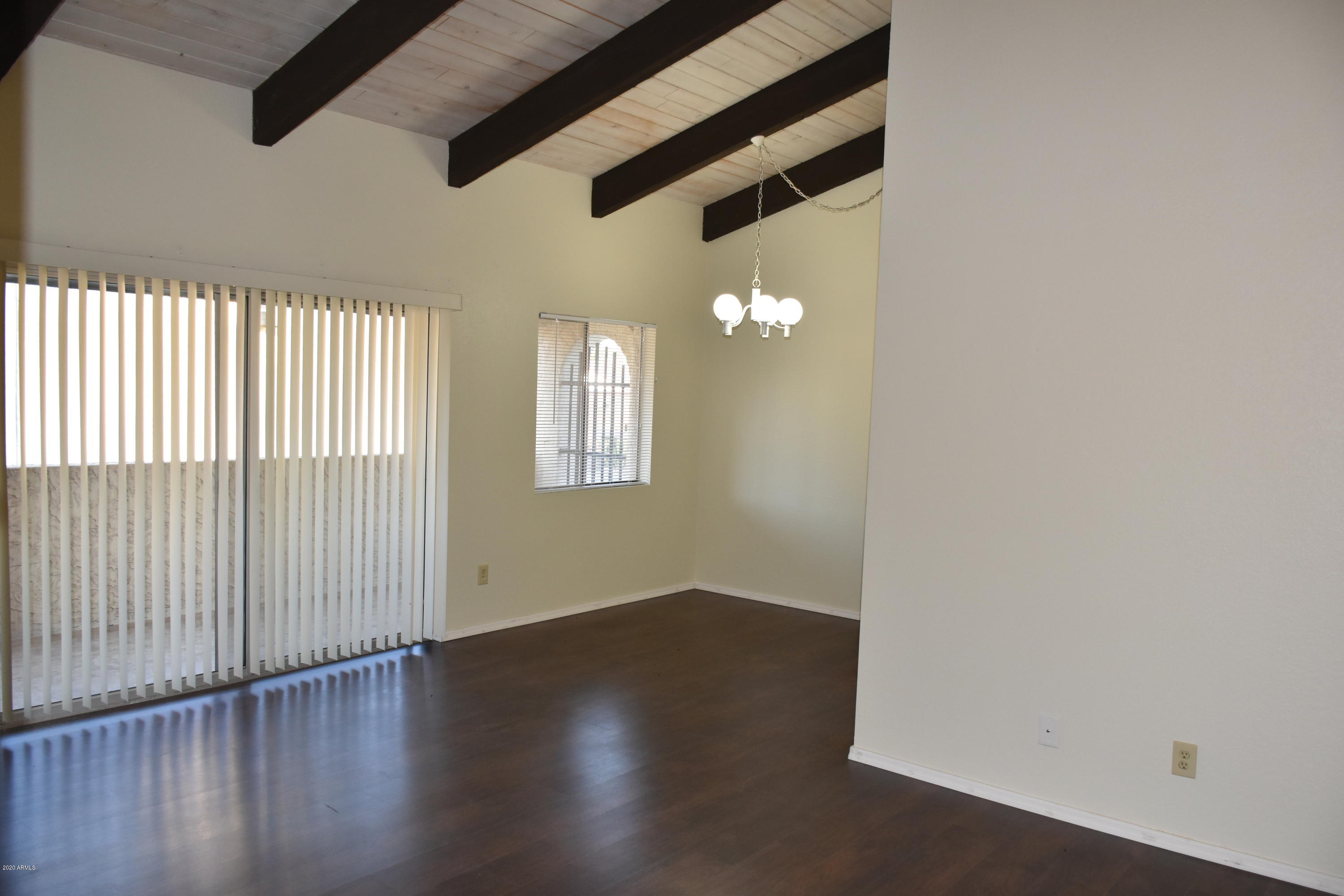 2060 South Rural Road, Unit C Tempe, AZ 85282 - Photo 8 of 8 an empty room with wooden floor and windows