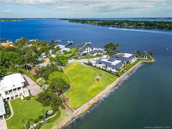 an aerial view of a residential houses with swimming pool