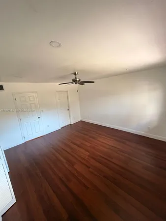 an empty room with wooden floor