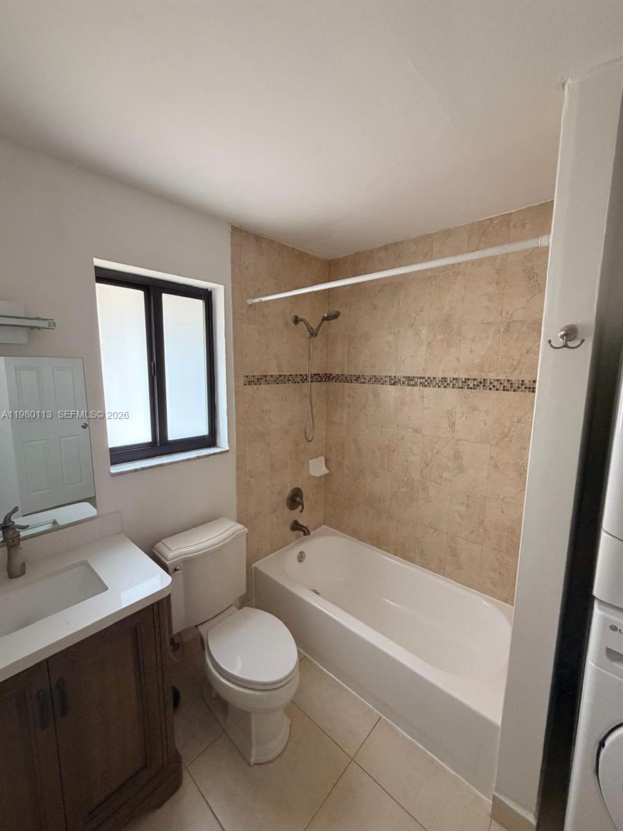 7101 Southwest 113th Court Miami, FL 33173 - Photo 18 of 30 a bathroom with a granite countertop bathtub shower sink vanity and toilet