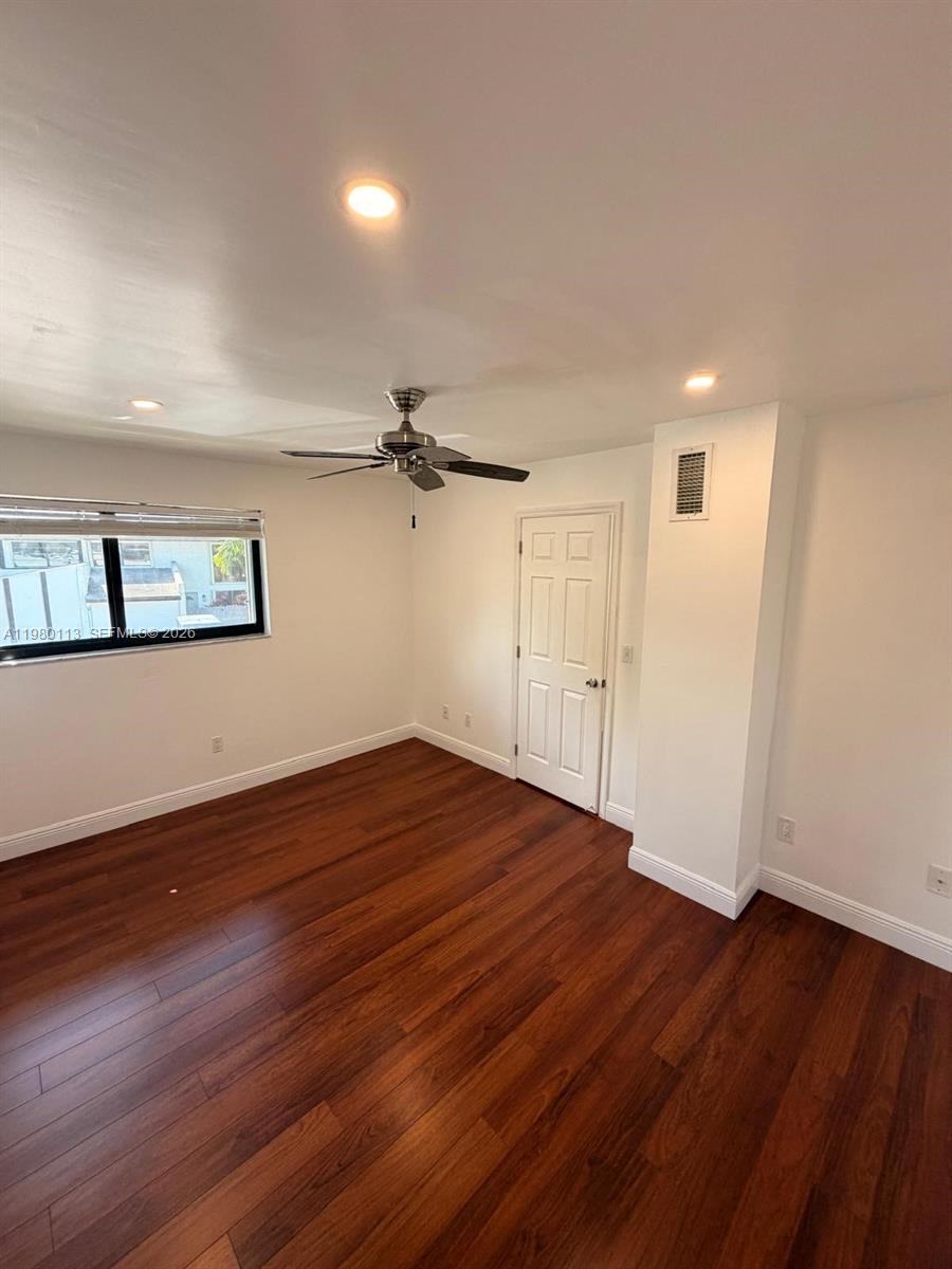 7101 Southwest 113th Court Miami, FL 33173 - Photo 21 of 30 wooden floor in an empty room with a window