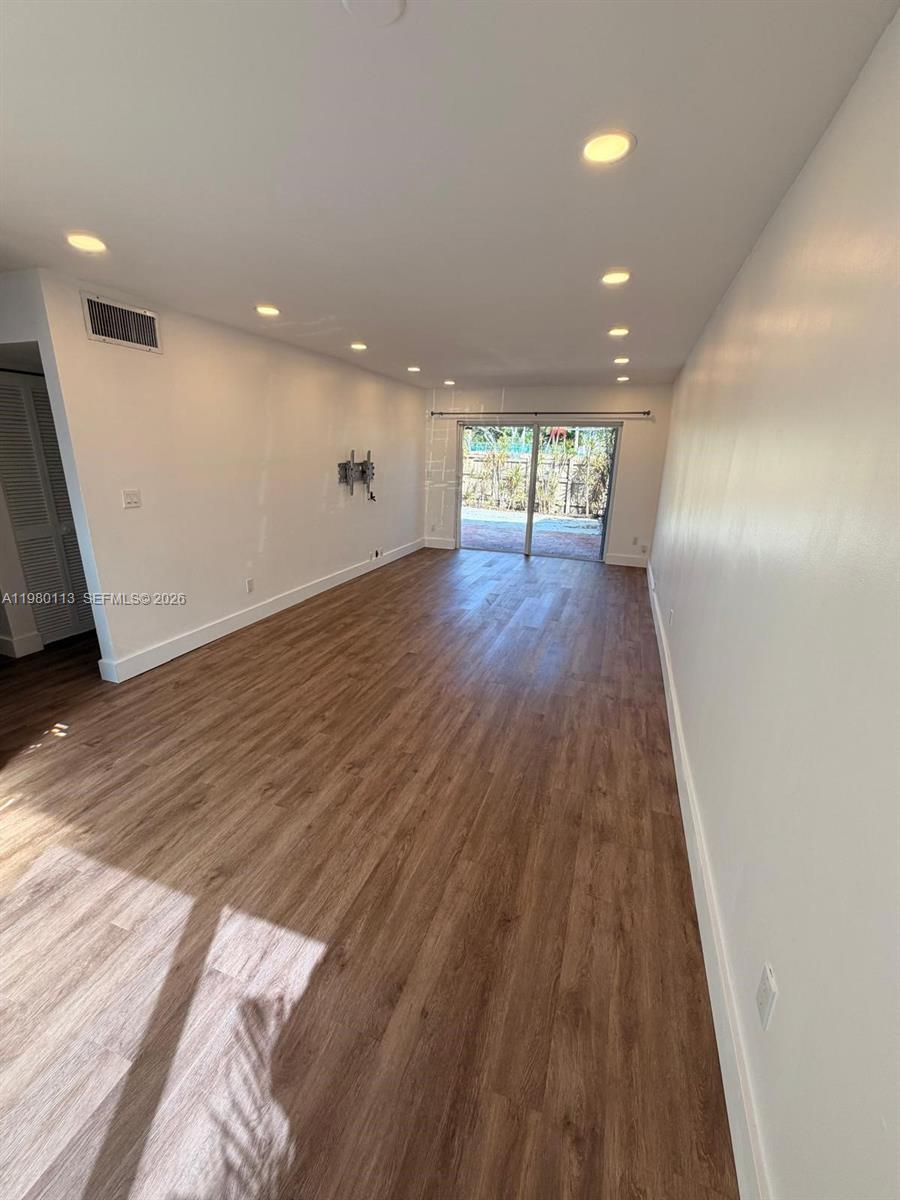 7101 Southwest 113th Court Miami, FL 33173 - Photo 6 of 30 wooden floor in an empty room with a window