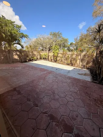 a view of large trees with a yard