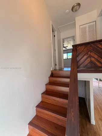 a view of entryway and hall with wooden floor