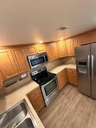 a kitchen with a stove a sink and a microwave