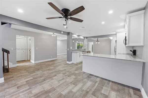 a view of a kitchen with a sink stainless steel appliances and cabinets