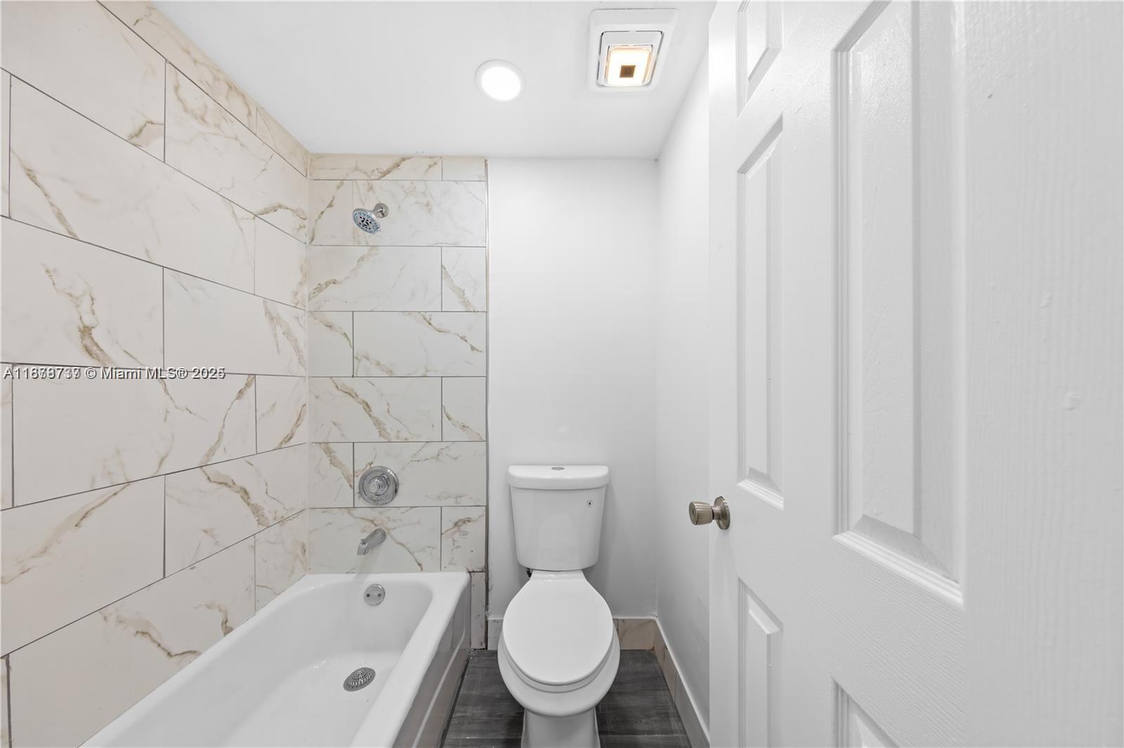 3680 Inverrary Drive, Unit 3J Lauderhill, FL 33319 - Photo 15 of 16 a bathroom with a toilet and a bathtub