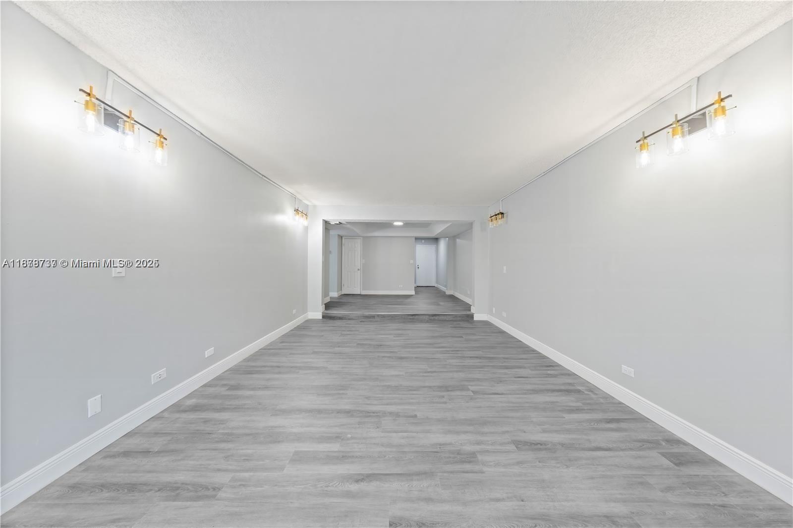 3680 Inverrary Drive, Unit 3J Lauderhill, FL 33319 - Photo 5 of 16 a view of a big room with wooden floor and windows