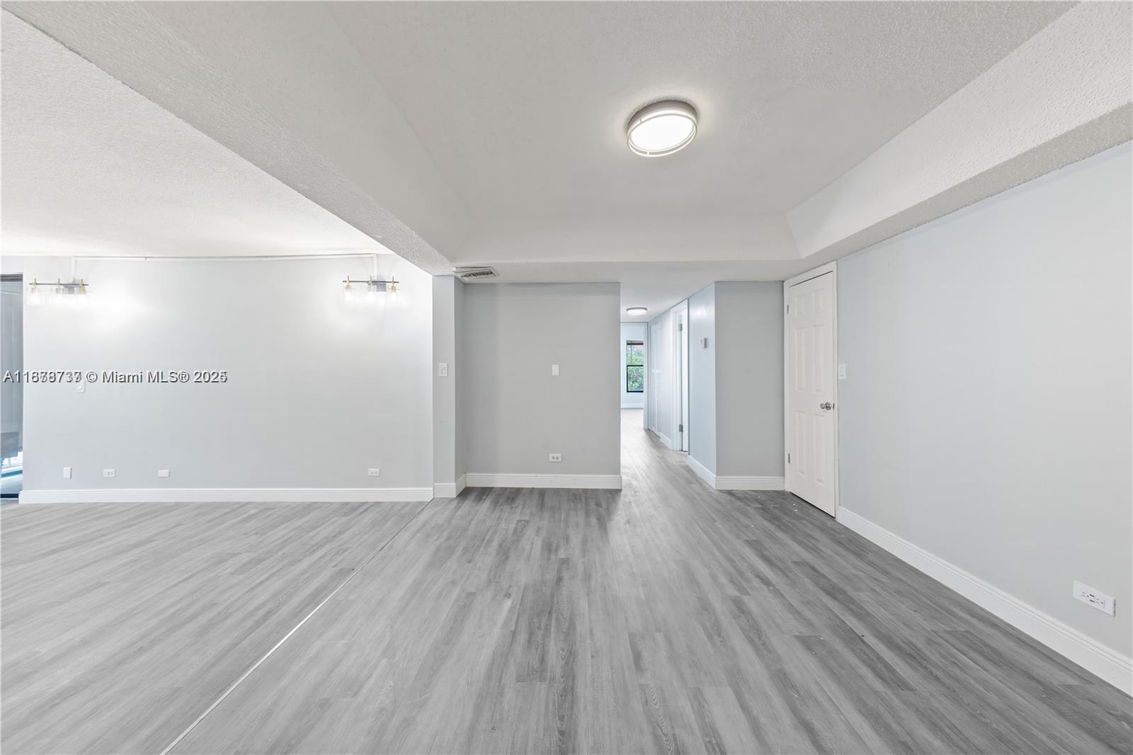 3680 Inverrary Drive, Unit 3J Lauderhill, FL 33319 - Photo 6 of 16 a view of an empty room and wooden floor