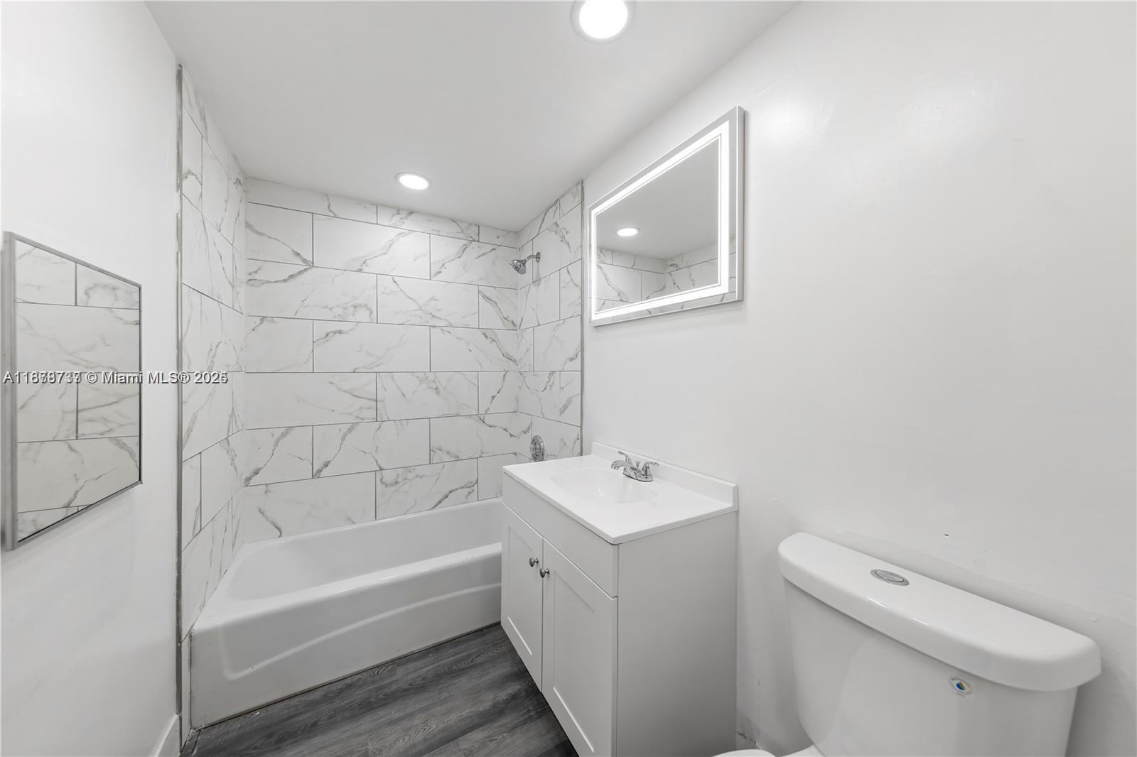 3680 Inverrary Drive, Unit 3J Lauderhill, FL 33319 - Photo 7 of 16 a bathroom with a bathtub a toilet and a shower