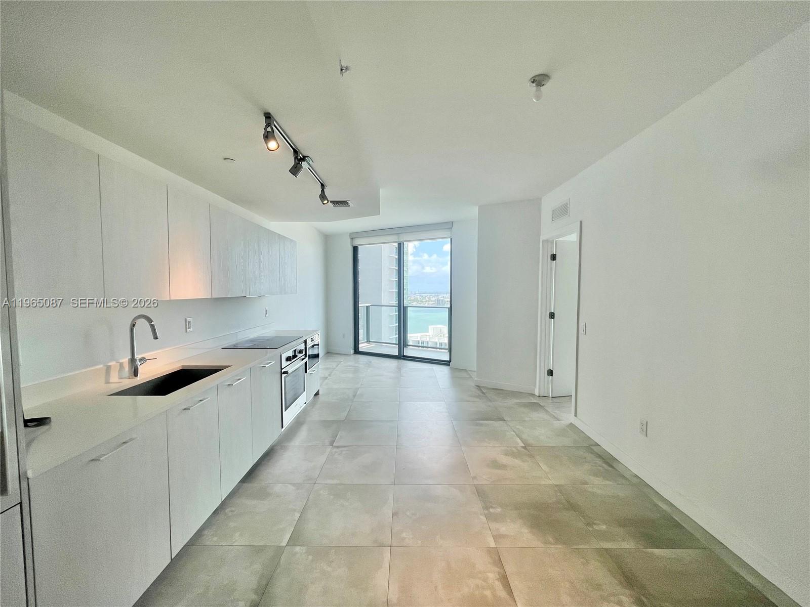 501 Northeast 31st Street, Unit 3007 Miami, FL 33137 - Photo 4 of 14 a view of a kitchen with electric appliances