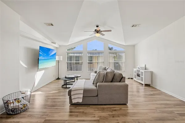 a living room with furniture and wooden floor