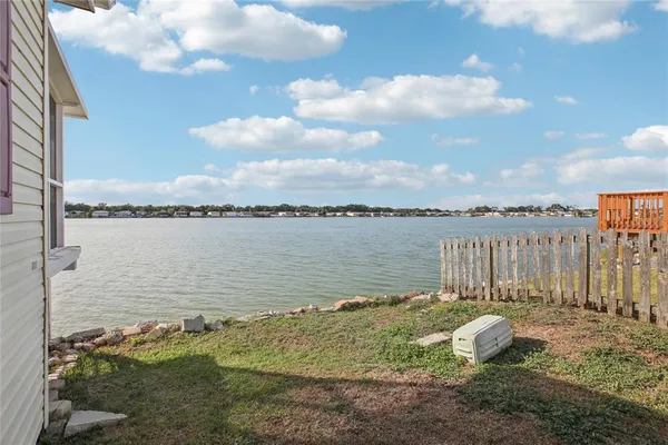 a view of a white house with a yard