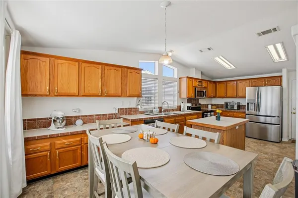 a kitchen with granite countertop a sink stove and refrigerator