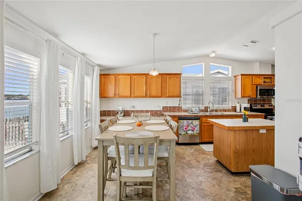 a dining room with furniture a chandelier and window