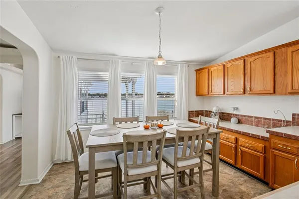 a kitchen with stainless steel appliances granite countertop a sink and a refrigerator