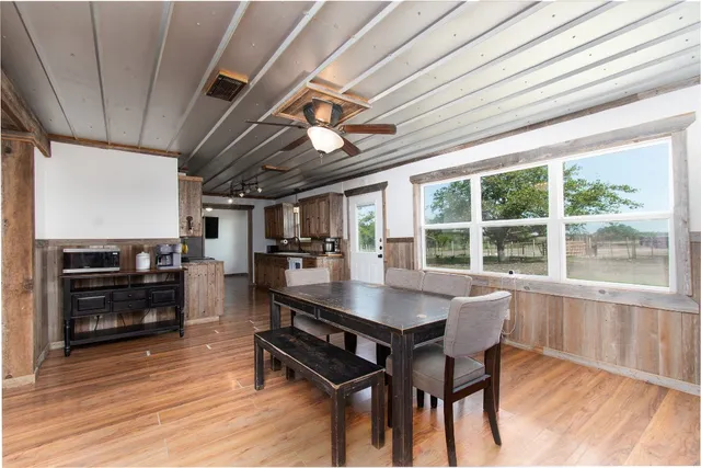 a dining room with furniture window and wooden floor
