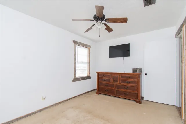a view of room with window and a ceiling fan