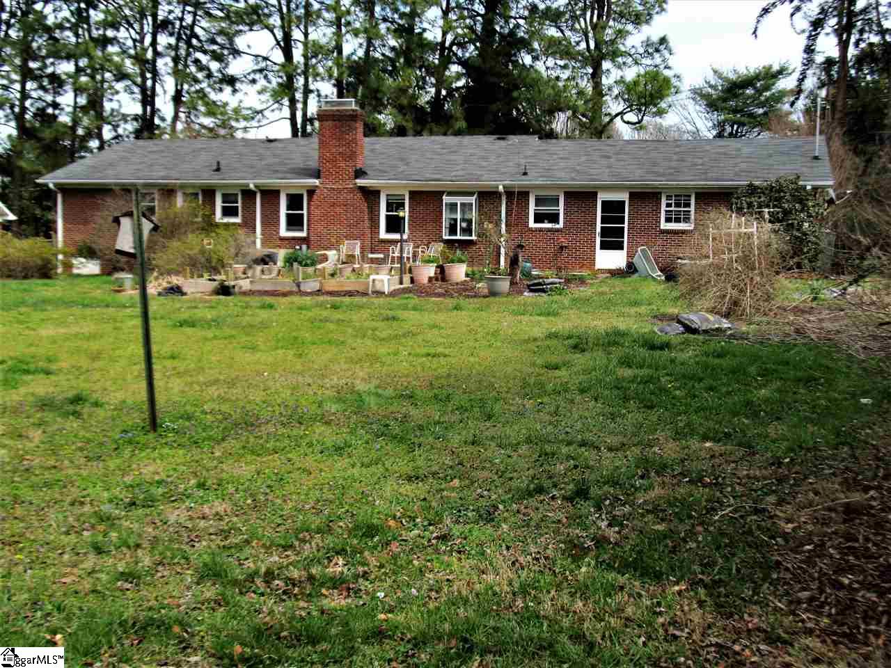 405 Butler Springs Road Greenville, SC 29615 - Photo 13 of 13 Large back yard with 3 raised flower beds and a patio.