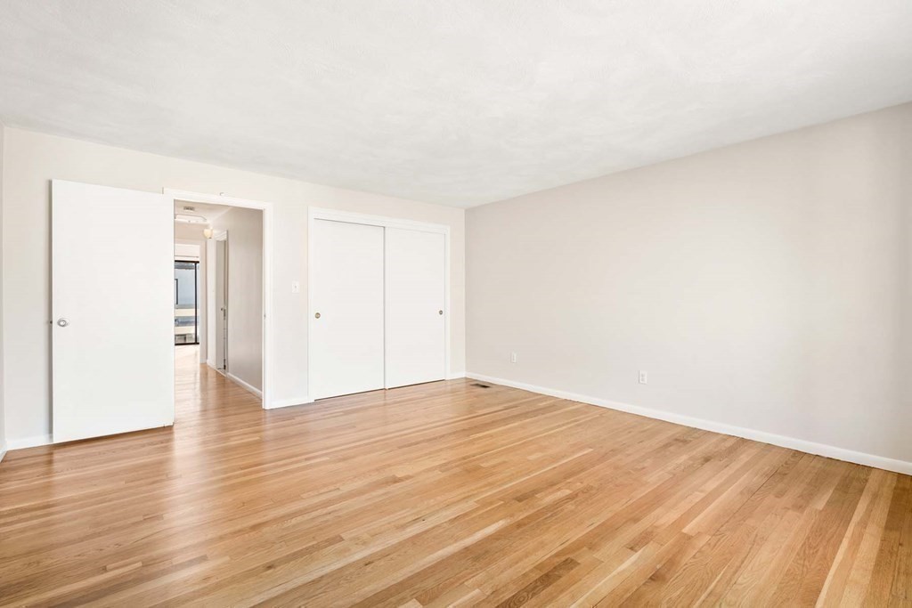 120 Beaconsfield Road, Unit 9 Brookline, MA 02445 - Photo 12 of 20 a view of an empty room and wooden floor