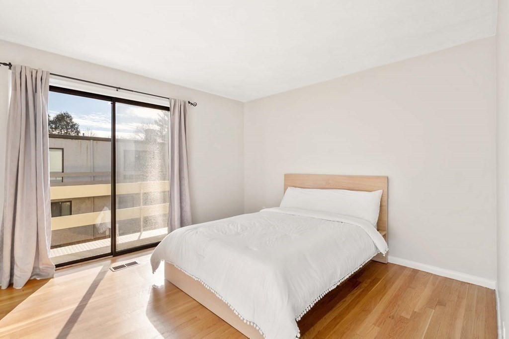 120 Beaconsfield Road, Unit 9 Brookline, MA 02445 - Photo 13 of 20 a large bed sitting in a bedroom next to a window