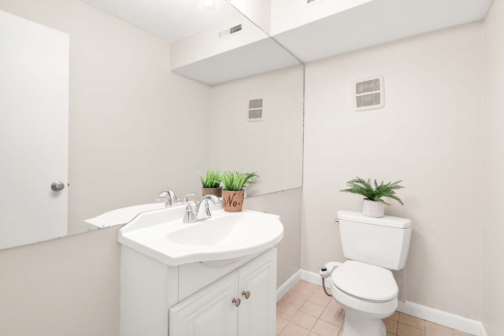120 Beaconsfield Road, Unit 9 Brookline, MA 02445 - Photo 18 of 20 a bathroom with a sink a toilet and a mirror
