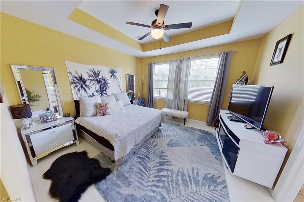 3970 Cherrybrook Loop Fort Myers, FL 33966 - Photo 13 of 21 a bedroom with a bed flat screen tv and a window