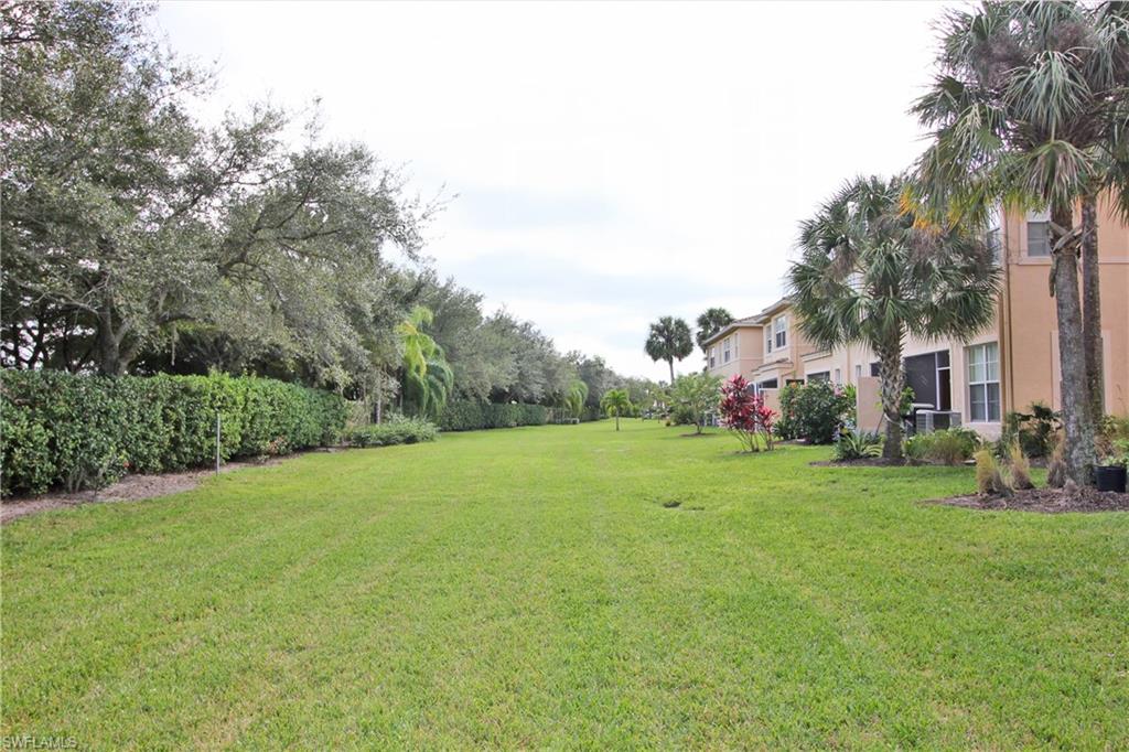 3970 Cherrybrook Loop Fort Myers, FL 33966 - Photo 18 of 21 a backyard of a house with plants and large trees
