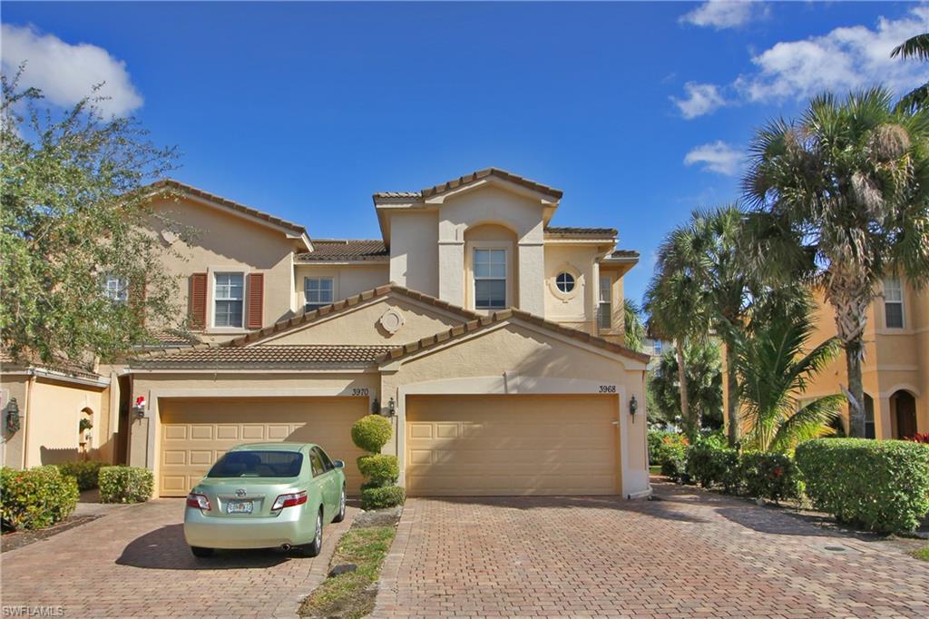 3970 Cherrybrook Loop Fort Myers, FL 33966 - Photo 2 of 21 a front view of a house with a garden and parking