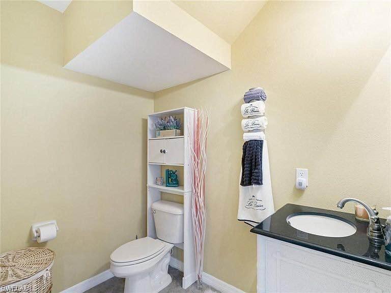 3970 Cherrybrook Loop Fort Myers, FL 33966 - Photo 6 of 21 a bathroom with a granite countertop sink mirror vanity and toilet