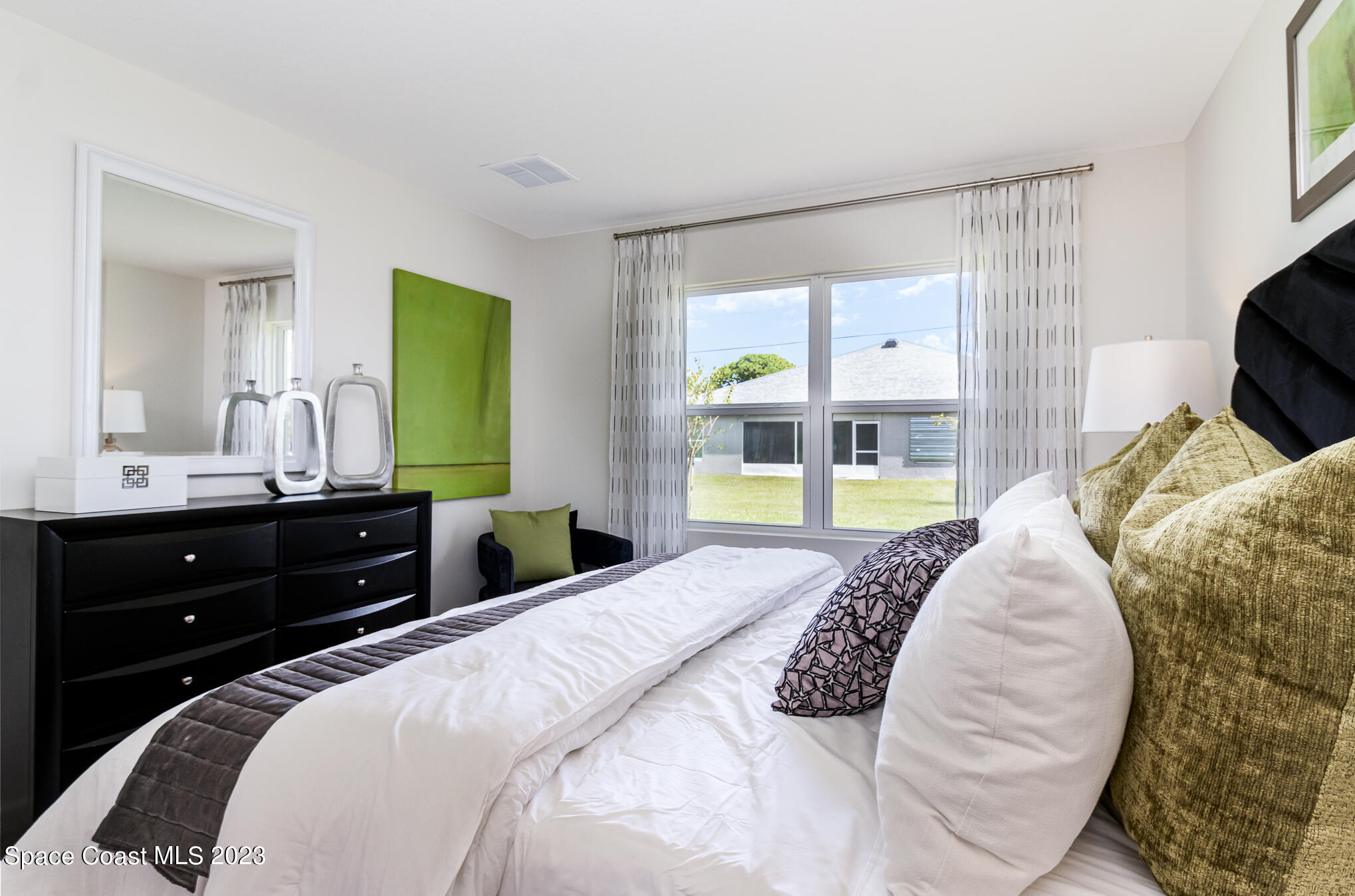 1920 Degroodt Road Southwest Palm Bay, FL 32908 - Photo 8 of 26 a bedroom with a bed and a window