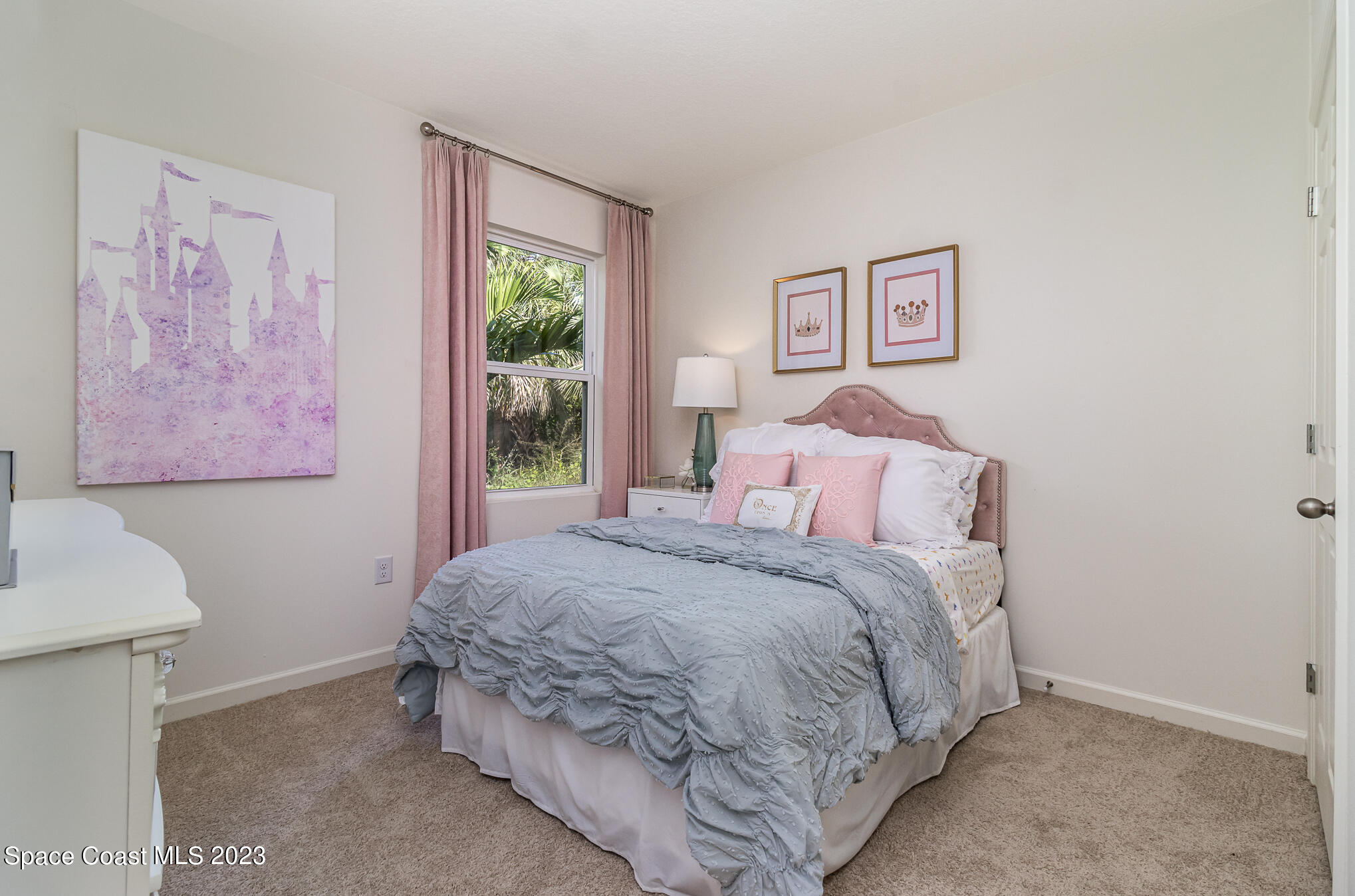 1920 Degroodt Road Southwest Palm Bay, FL 32908 - Photo 10 of 26 a bedroom with a bed and a window