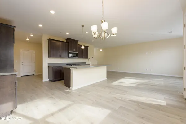 a view of a kitchen with a sink and chandelier