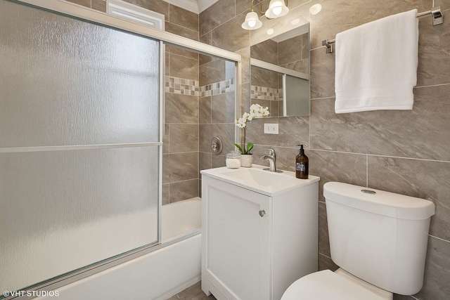 642 East 90th Street Chicago, IL 60619 - Photo 8 of 13 a bathroom with a toilet sink and shower