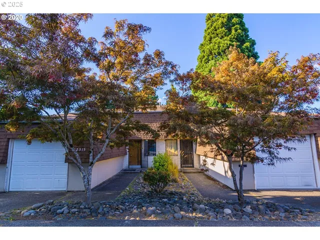 a view of a house with a tree