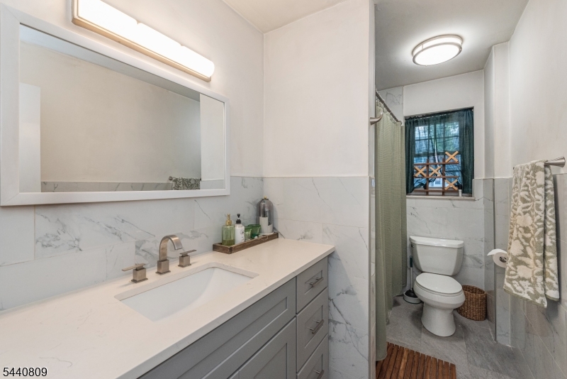 206 Main Street, Unit 42A Millburn, NJ 07041 - Photo 16 of 21 a bathroom with a sink toilet and shower